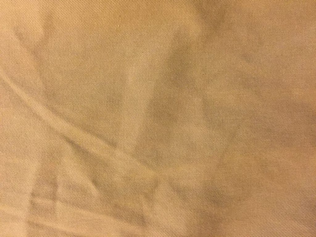 Wide shot of wrinkled khaki fabric