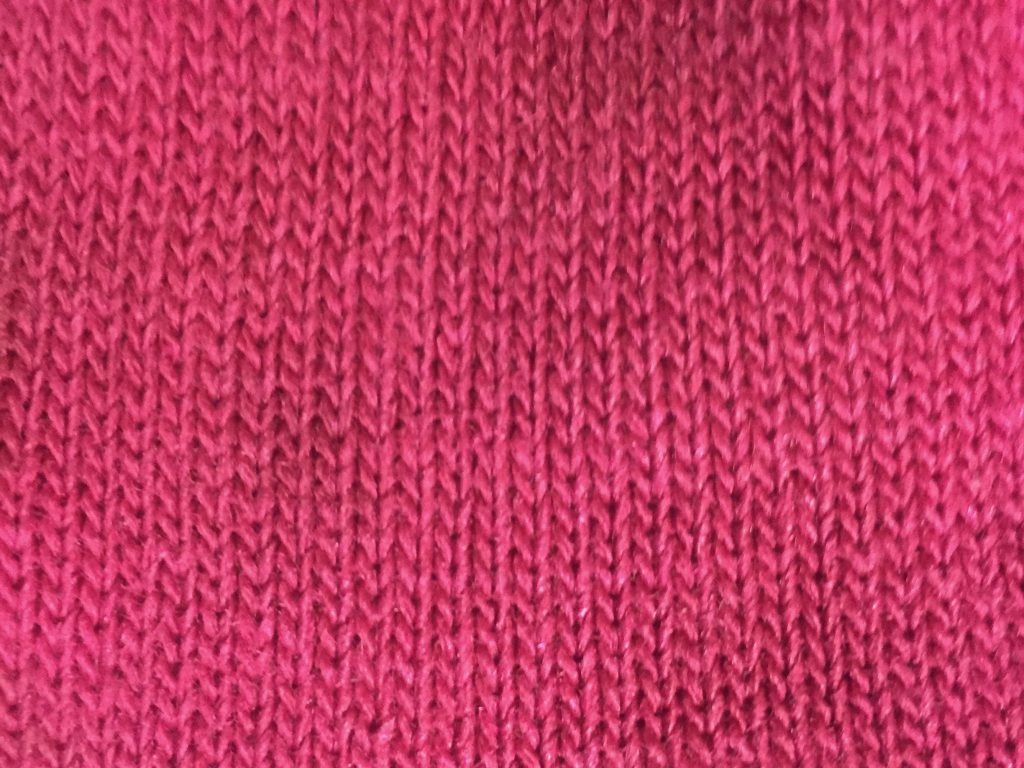 Loose pink knitted cotton fabric