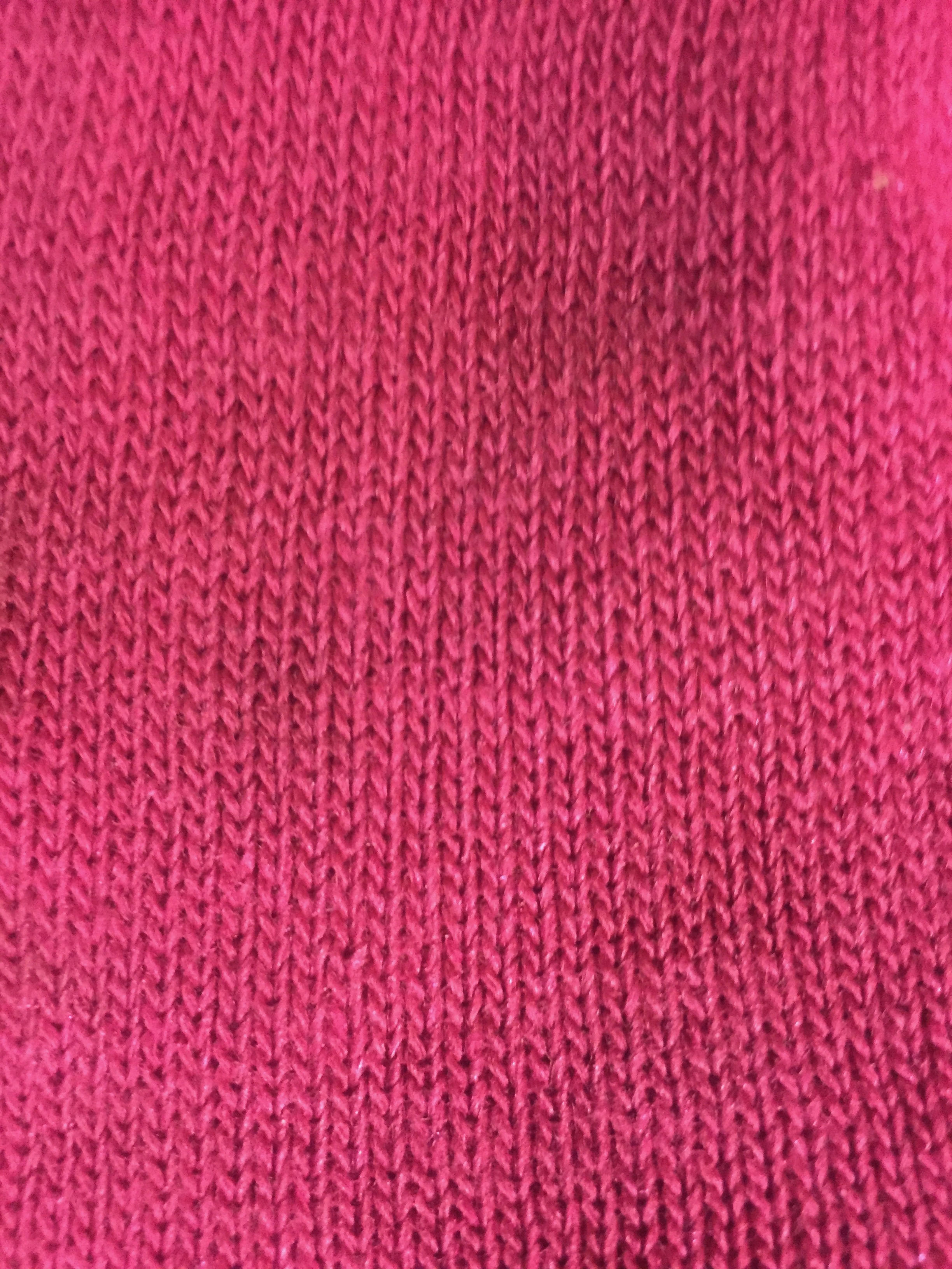 Loose pink knitted cotton fabric texture