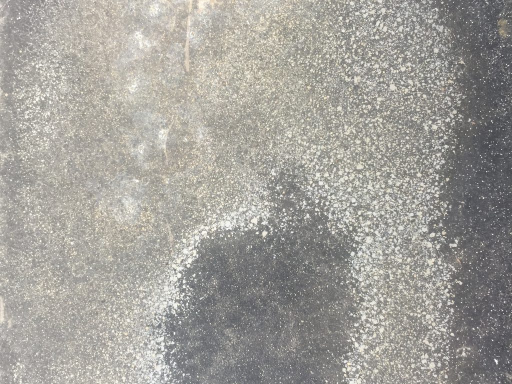 Spotted corrosion on white and grey metal surface