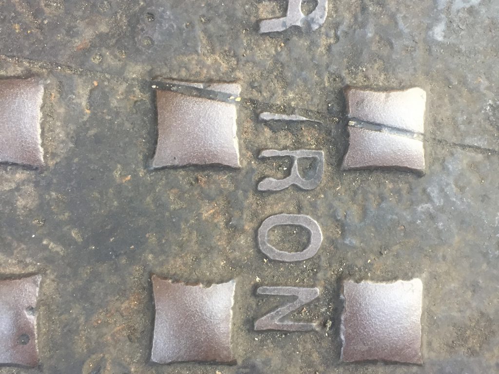 Dark grey and dark brown forged iron metal