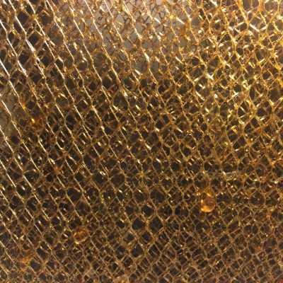 Layers of brass mesh with golden sap