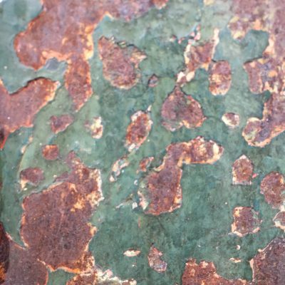 Dark green scuffed paint with rusty metal