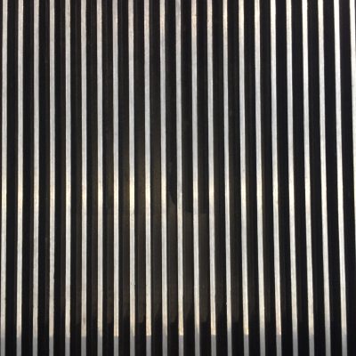 Thick metallic ridges of black and white vertical lines