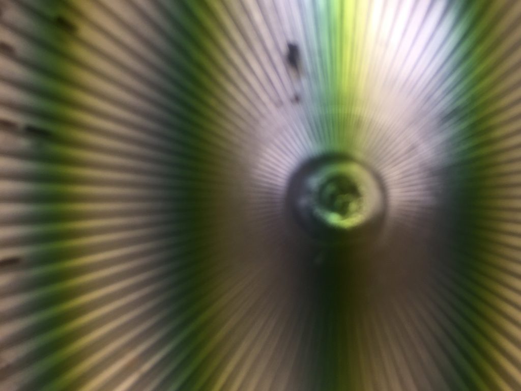 Abstract texture with radial lines and green/yellow vertical bars