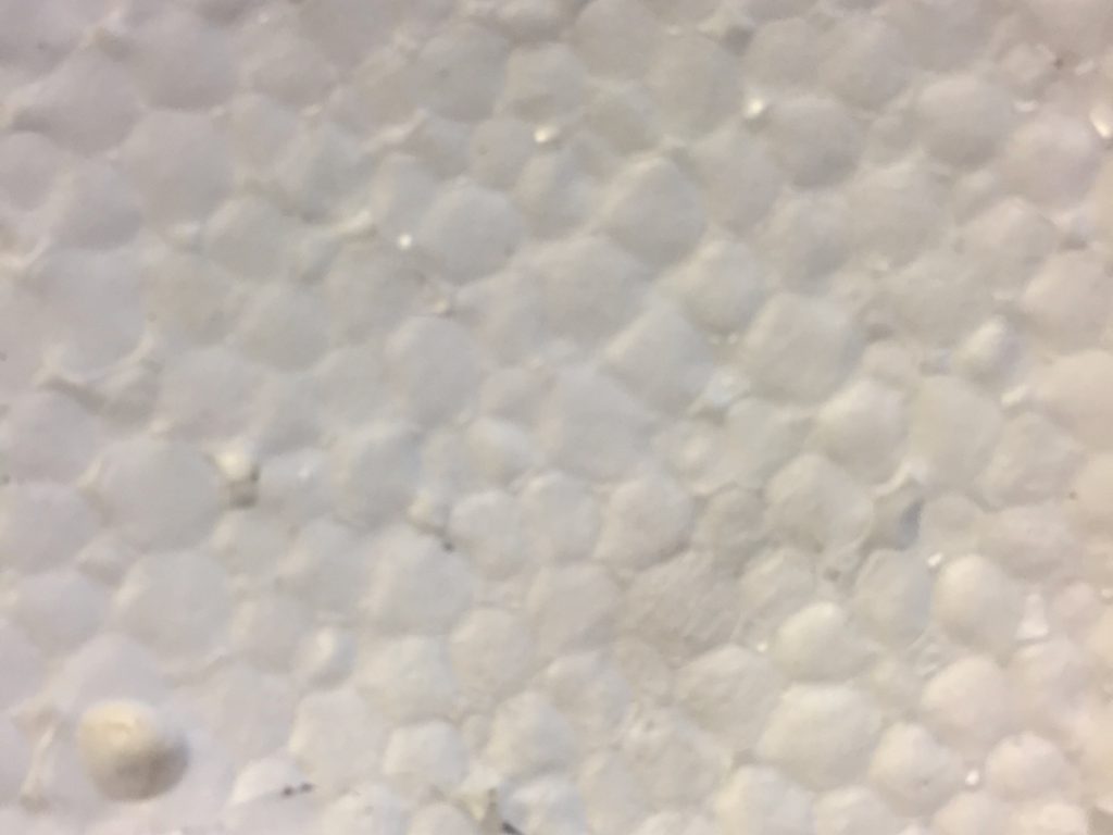 Off white styrofoam dented texture pattern