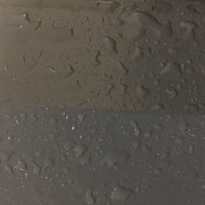 Charcoal grey paint with water drops sitting on top