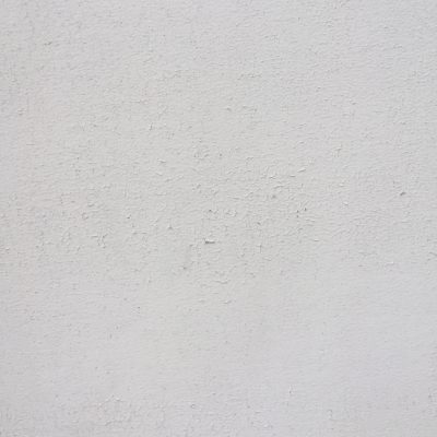 Paint chips on white concrete wall creating nice texture