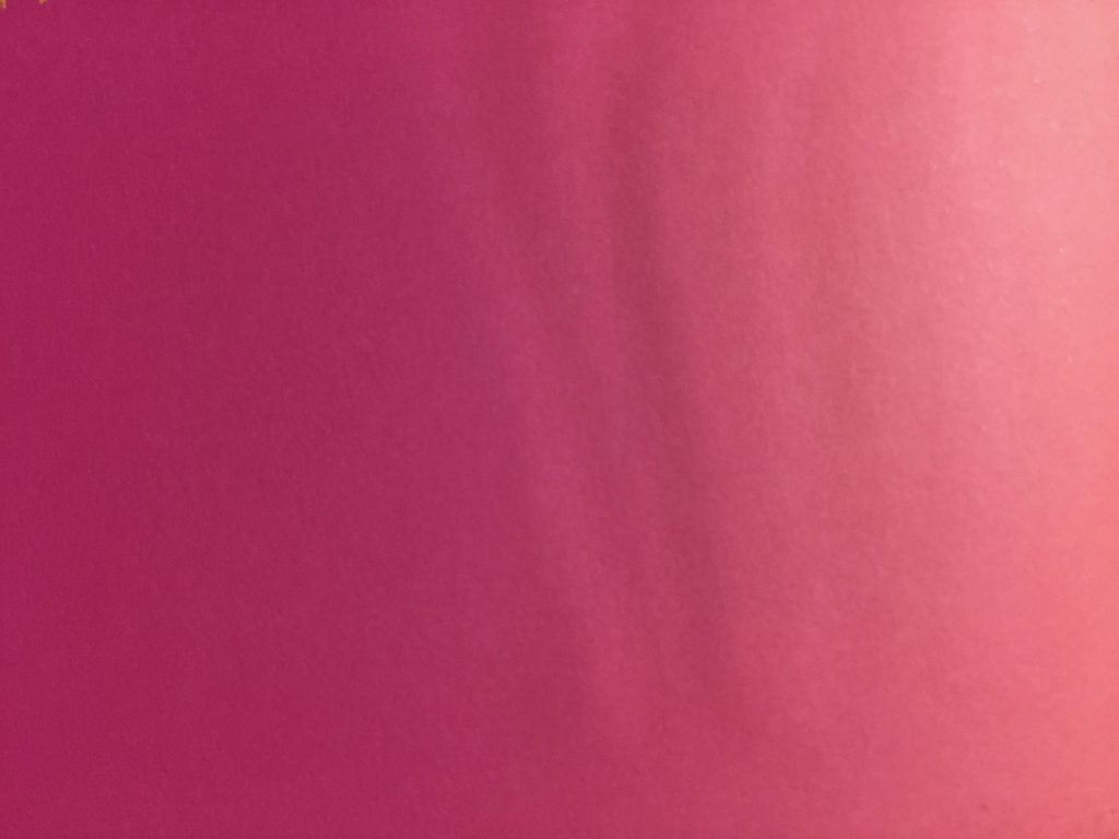 Pink paper texture with ripples creating gradient of color