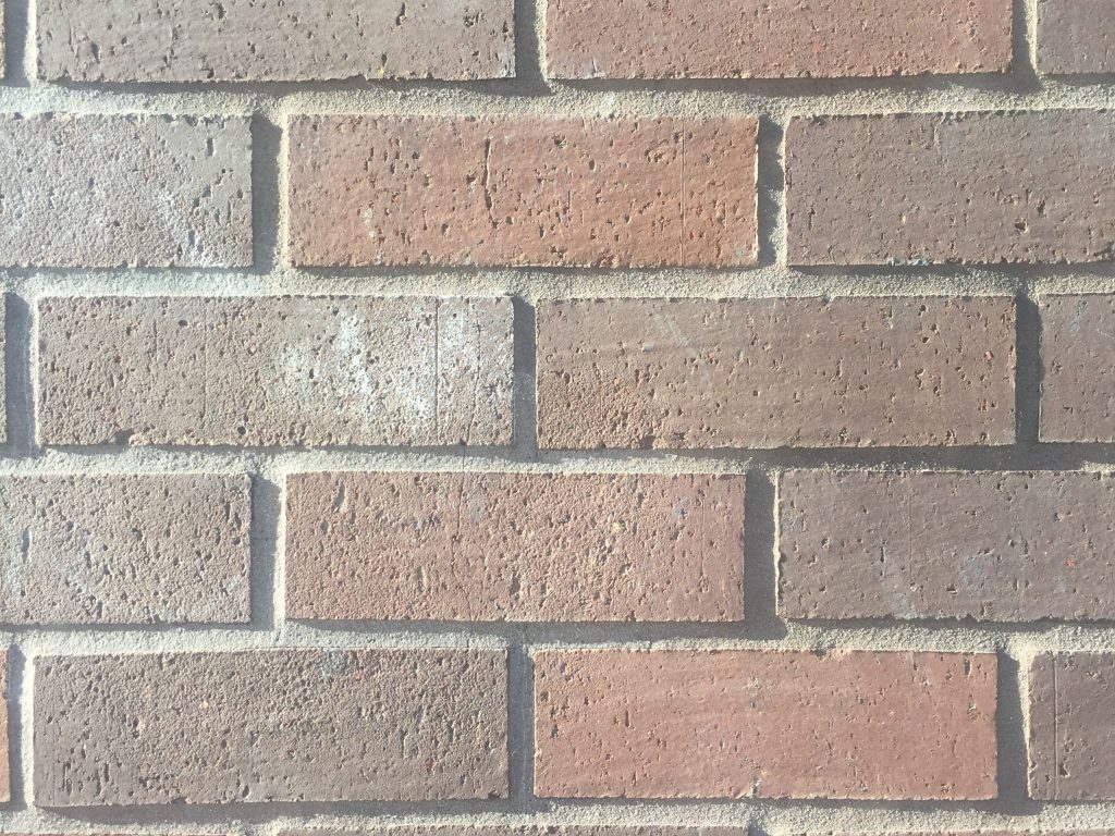 Pattern of bright bricks with alternating shades of red
