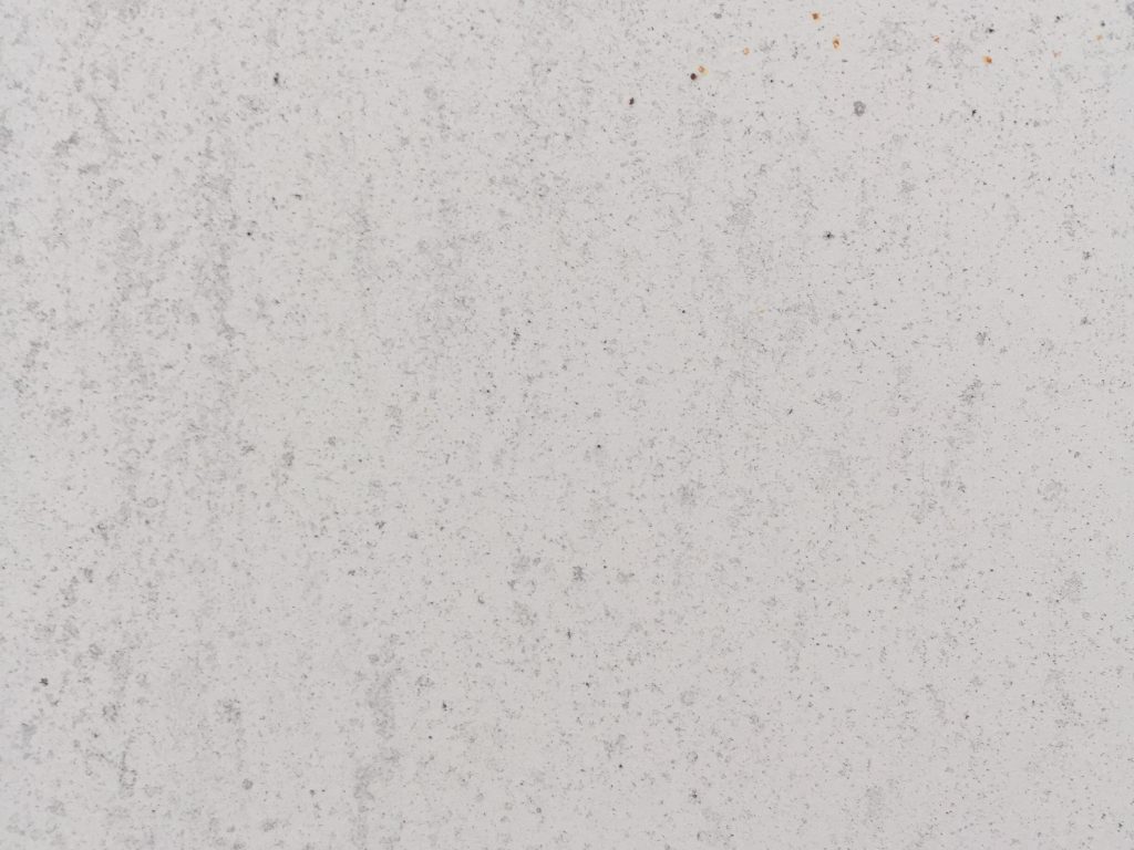Off white concrete wall with texture and specs