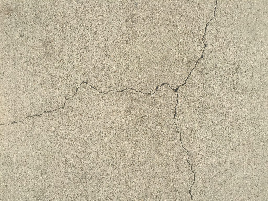 Lightly textured clean concrete with fractured crack