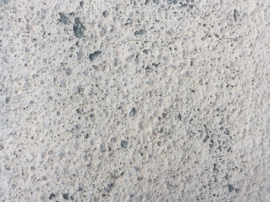 Light grey concrete with patterns of pebbles