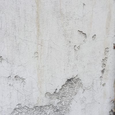 Off white dirty deteriorating plaster wall
