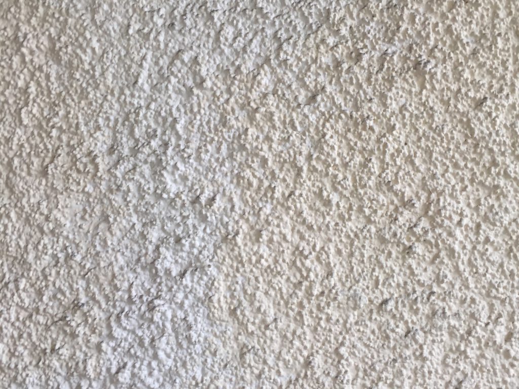 Off white stucco with bleach white streak texture