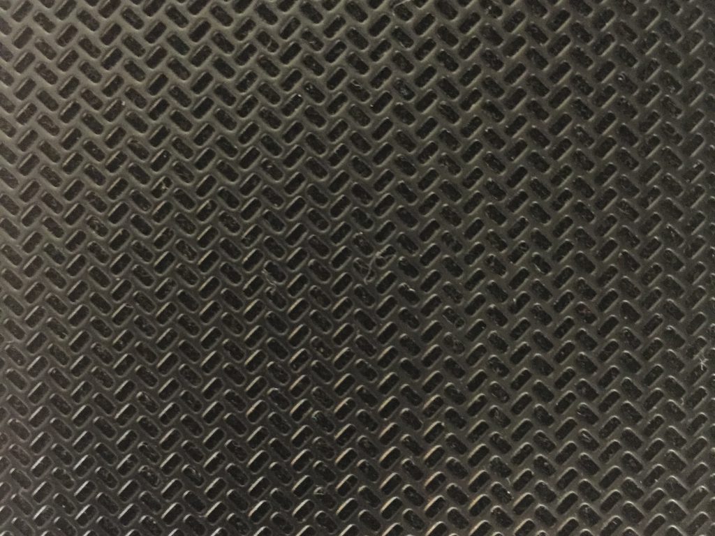 Dark black and grey plastic pattern with glossy edges
