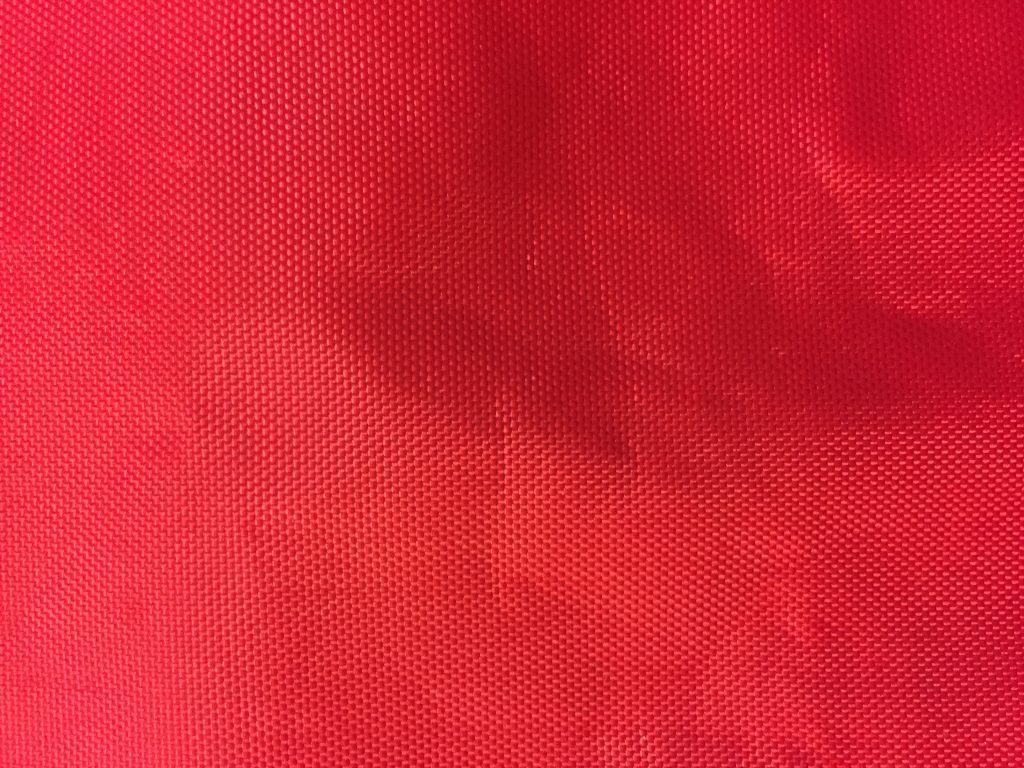 Bright red plastic bag with dotted texture