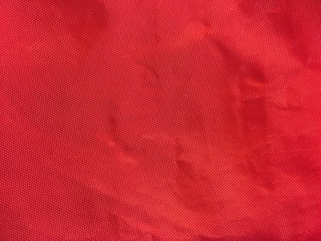 Bright red plastic bag with dotted texture