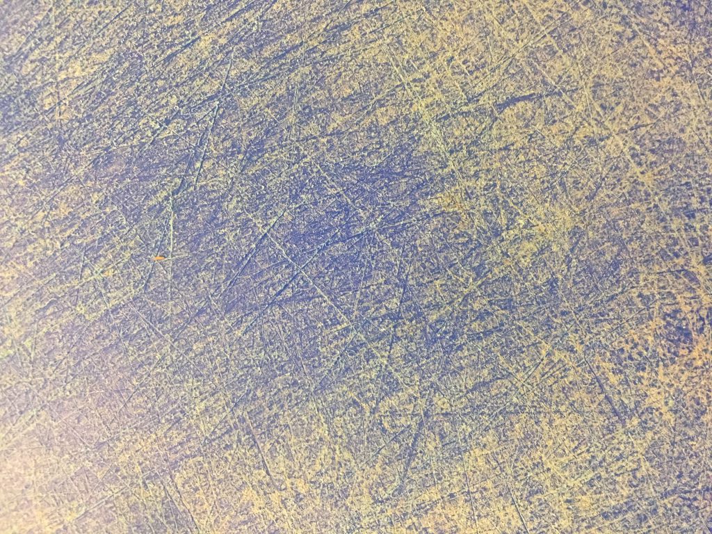Blue cutting board covered with scratches texture