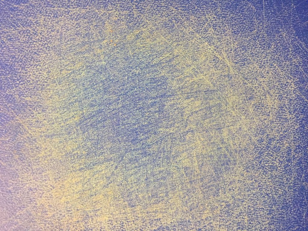 Blue cutting board filled with scratches