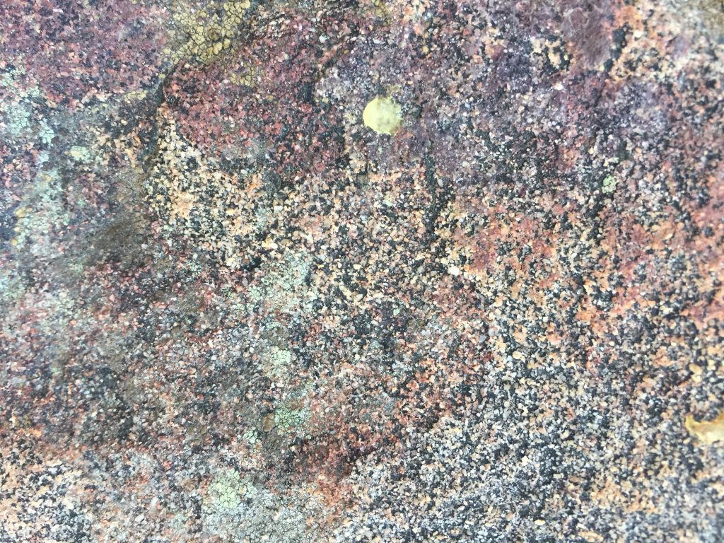 Colorful speckled rock face texture