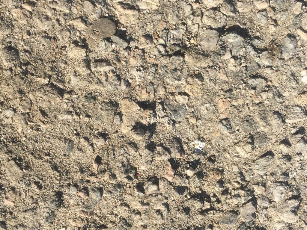 Grey composite rock with rough texture