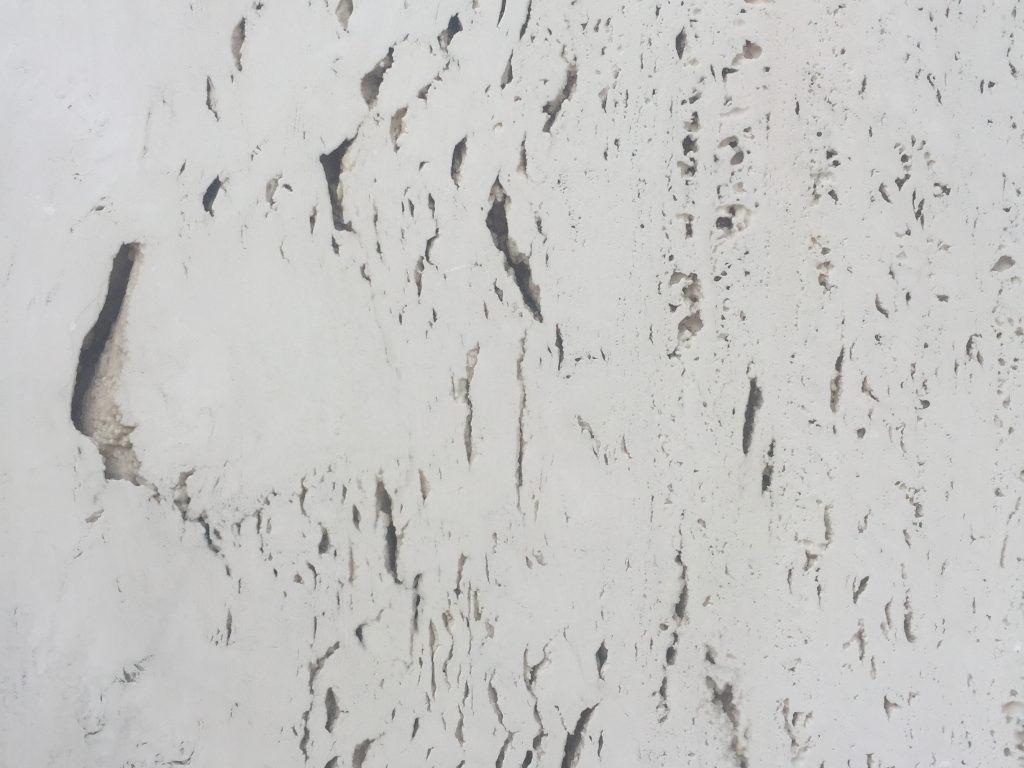 Pearl white rock wall of building exterior