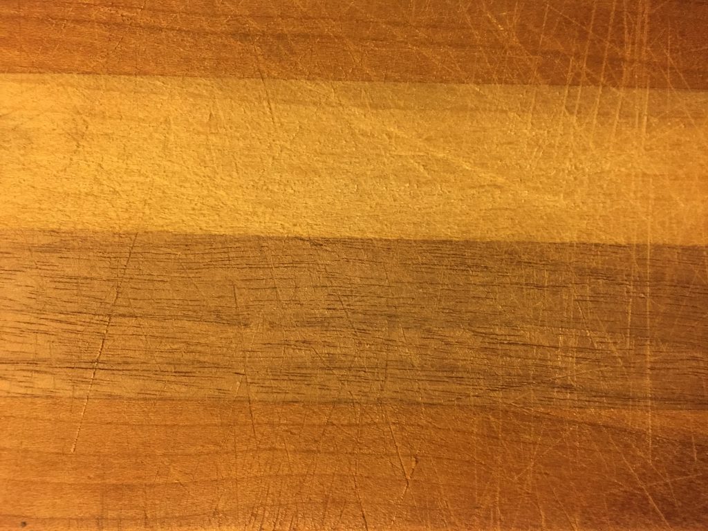 close up of wood with score marks over top of grain
