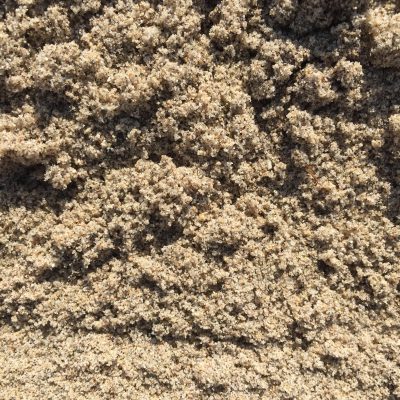 Close up light brown crumbly grains of sand