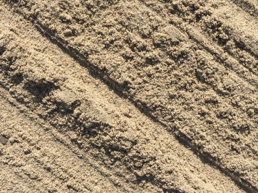 Crumbly light brown sand with ridges texture