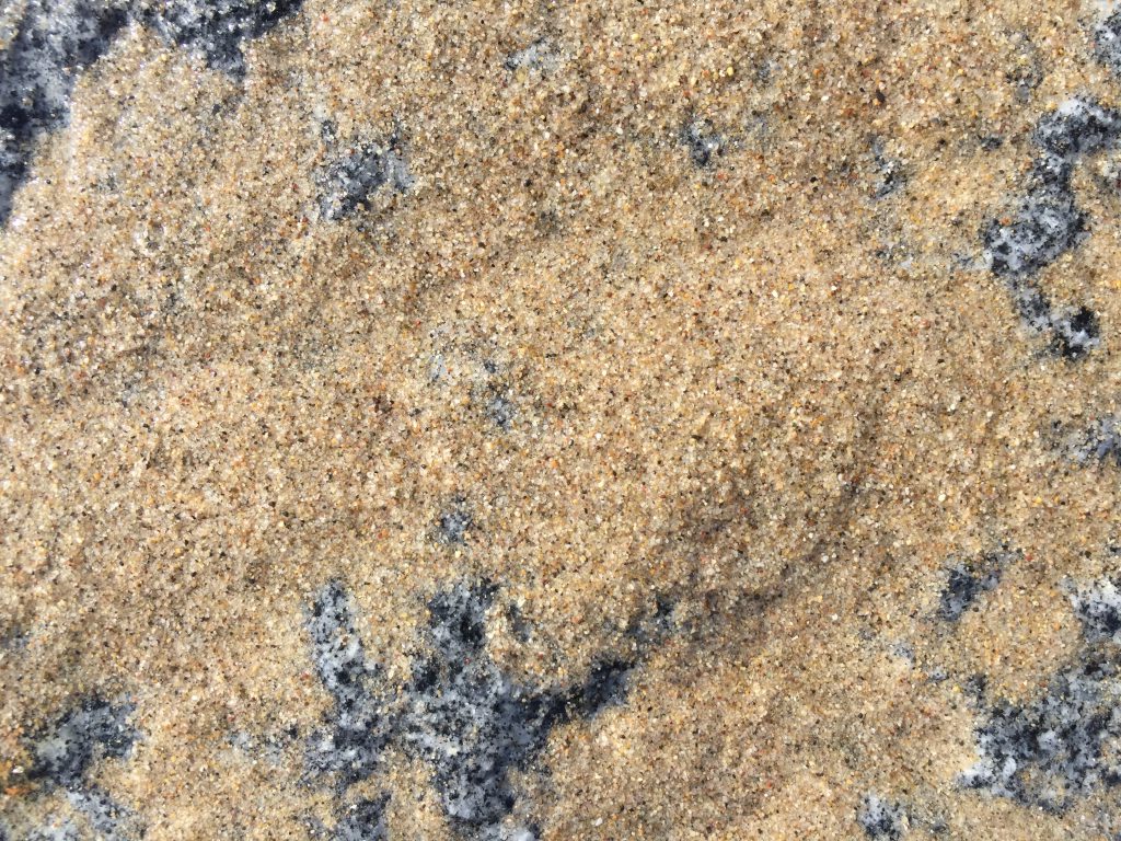 Wet sand over granite rock texture