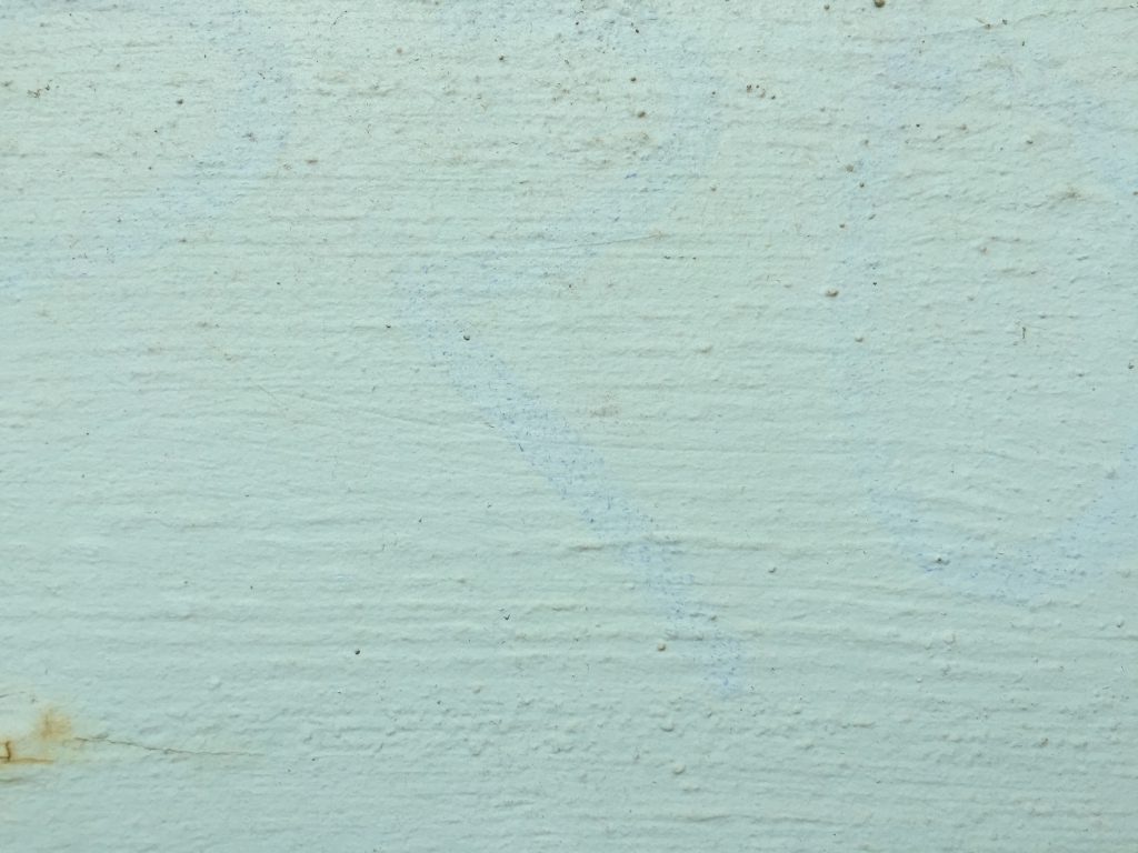 Concrete wall with teal paint featuring great texture