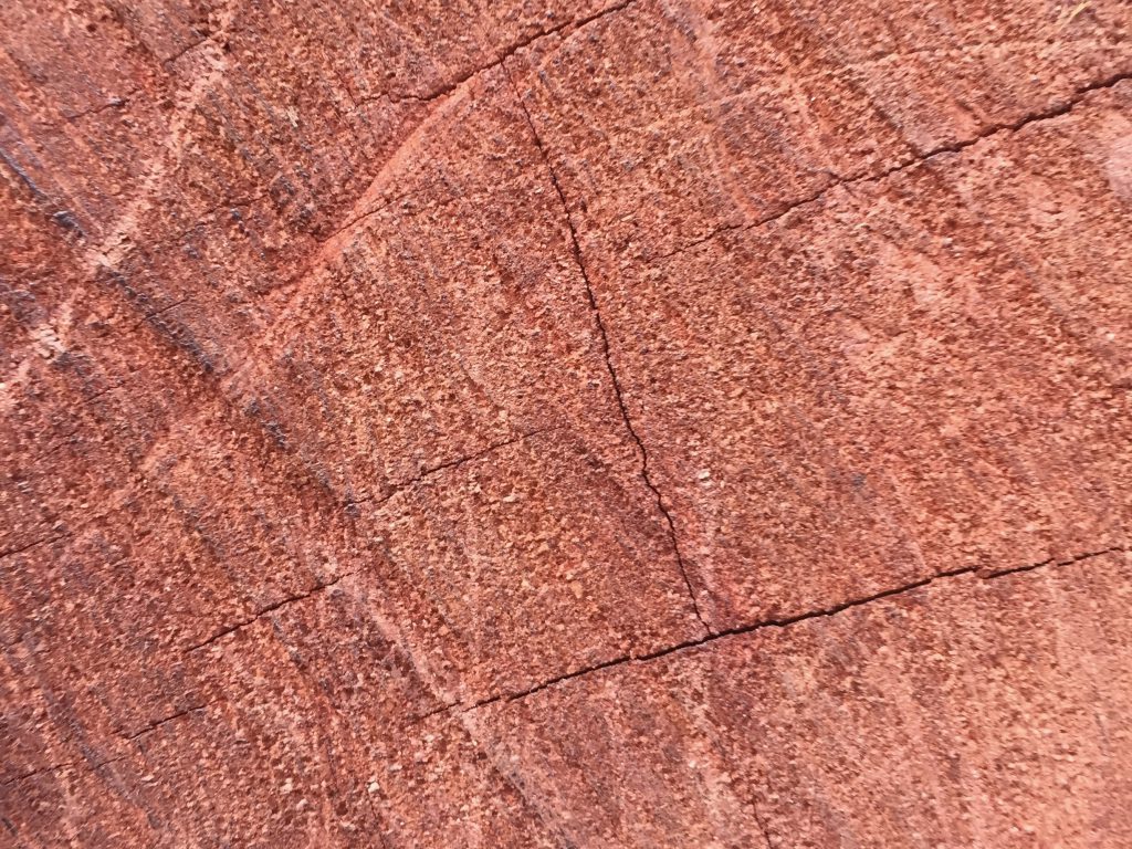 Close up of red wood grain with saw marks texture
