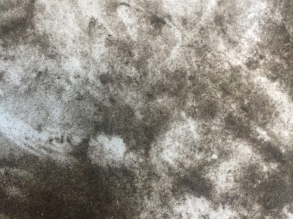 Dark soot over bright white surface