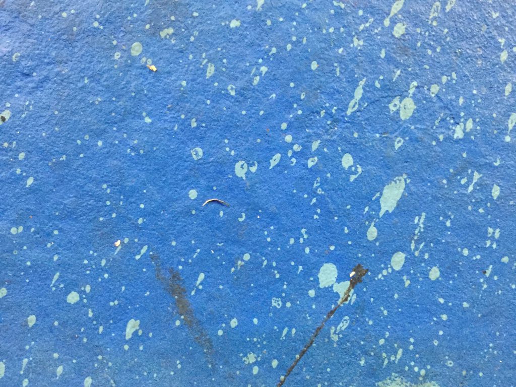 Blue concrete with light blue paint splatters