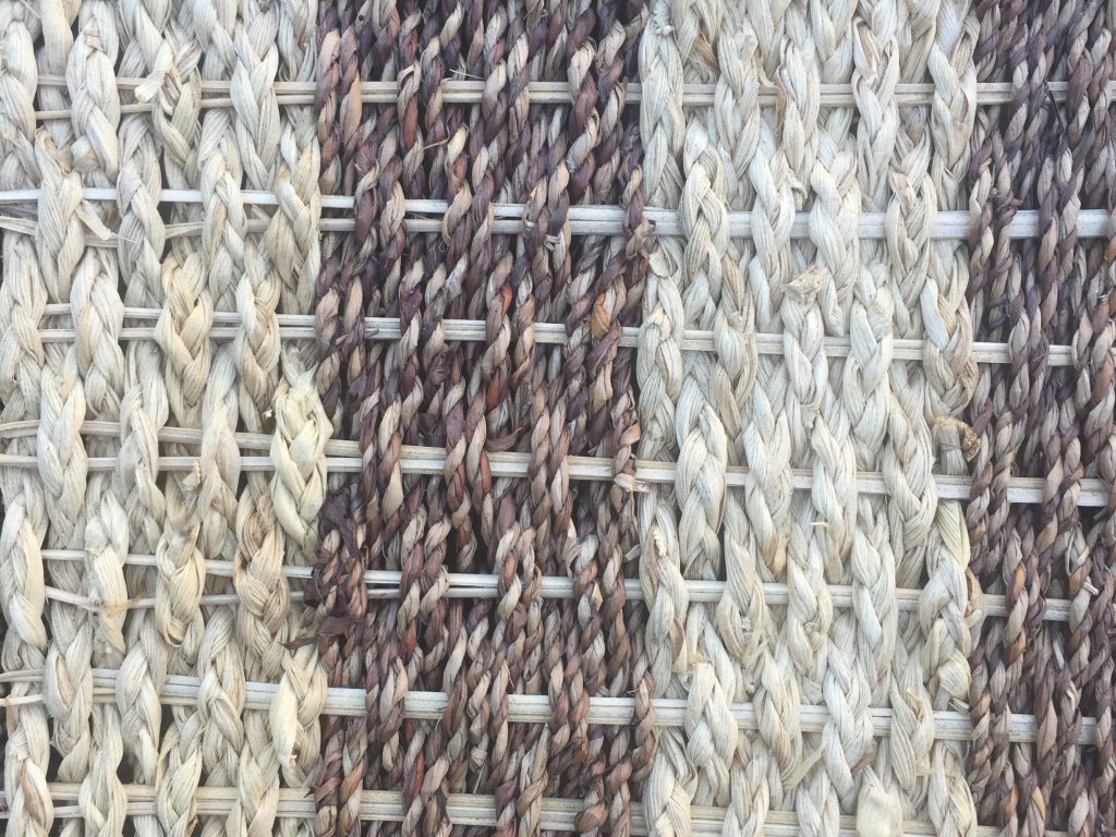 Tightly knit white and brown woven basket close up