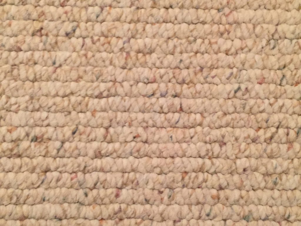 Off white closed loop carpet texture with speckled colors