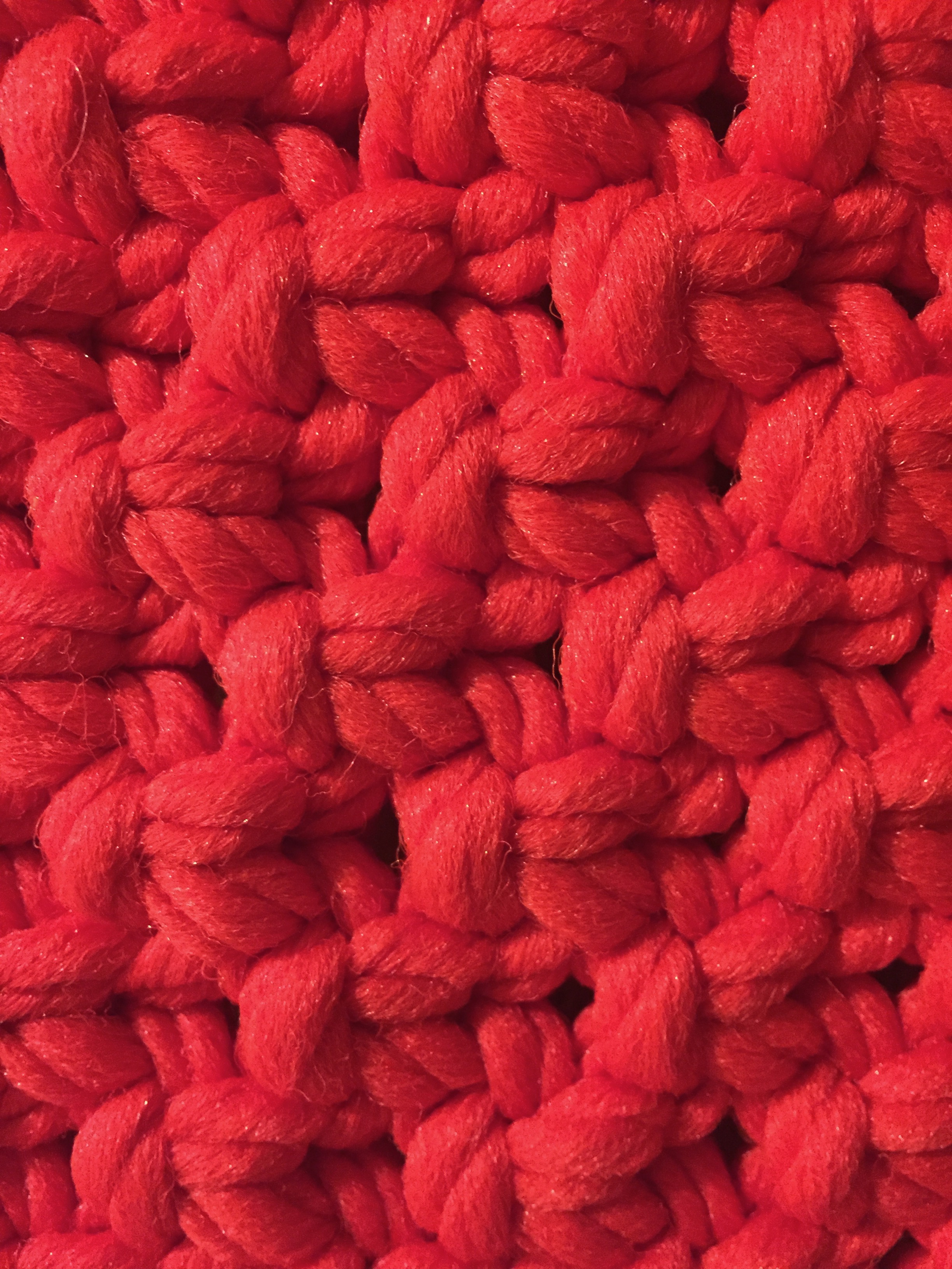 Bright red knit wool layers of texture