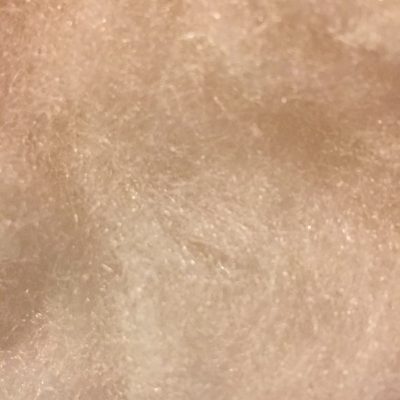 Extreme close up of loose white cotton fibers with subtle texture