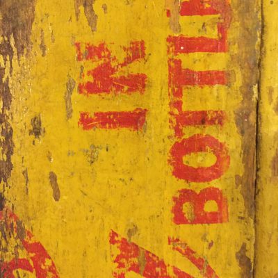 Yellow and red paint on old wood coke crate