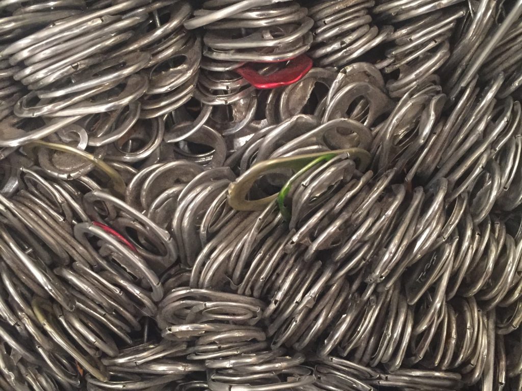 Detailed shot of hundreds of metal can tabs