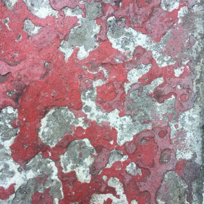 Beat up metal with red flaking paint