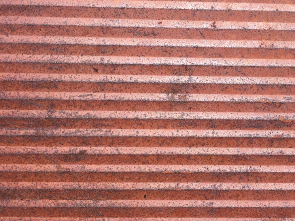 Angled metal wall with rust and corrosion