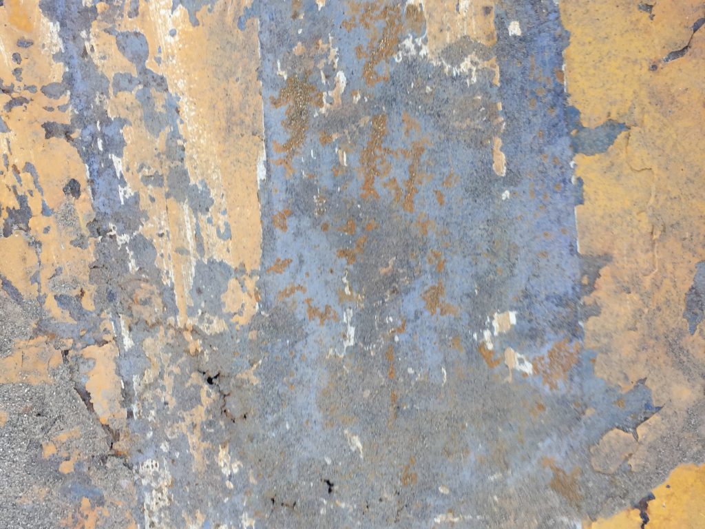 Rusted metal with orange yellow paint
