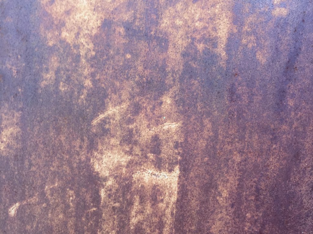 Black rust on flat metal surface