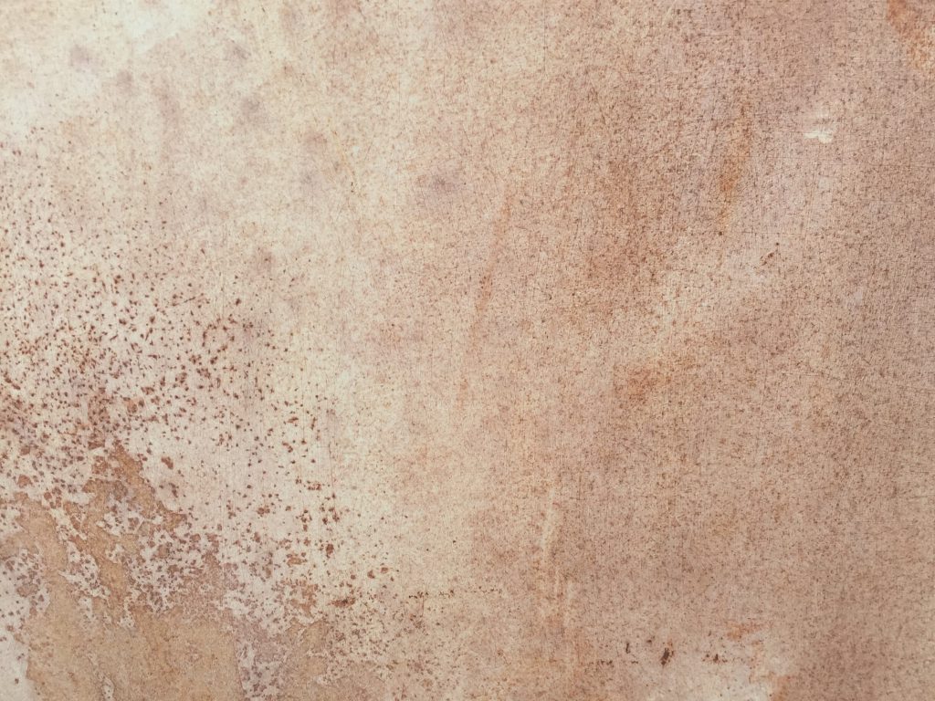 Cream colored white paint with light brown rust below