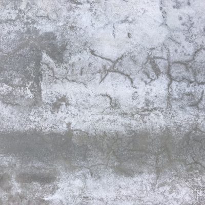 Concrete slab texture with light cracks and thin layer of white corrosion