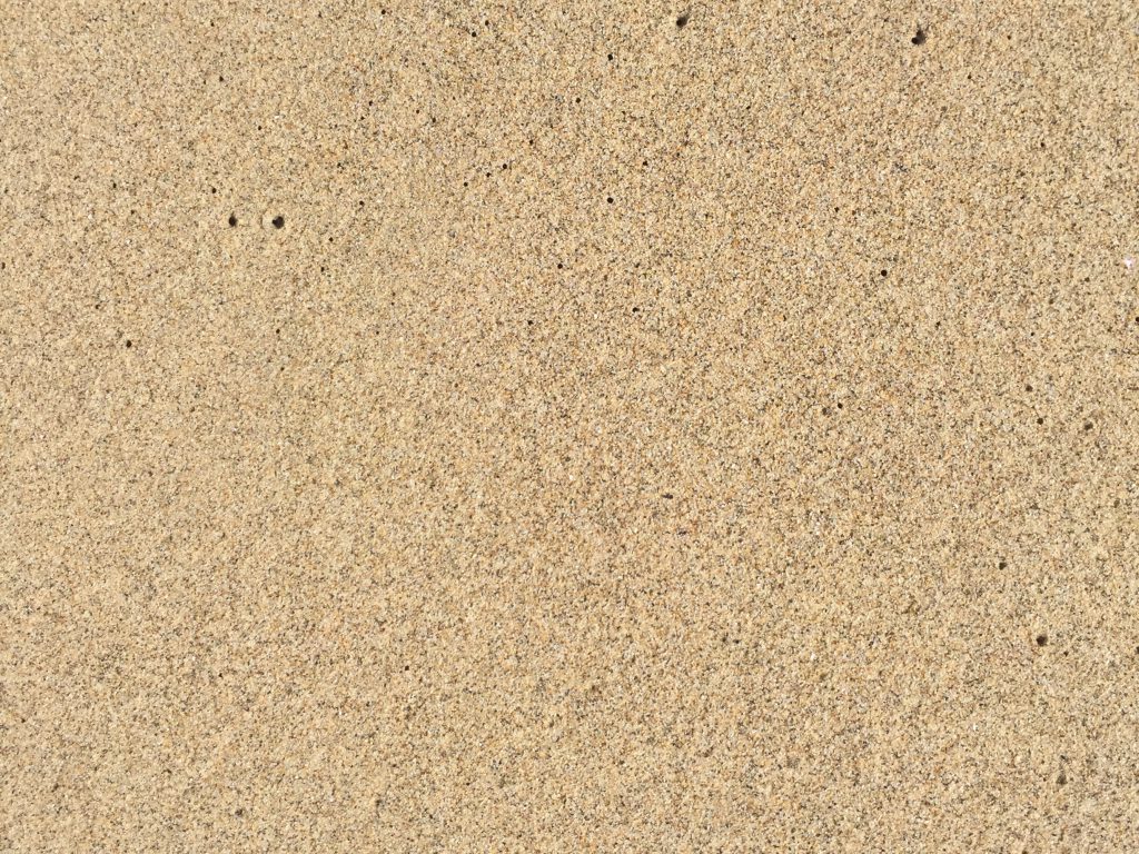 Smooth wet sandy beach close up