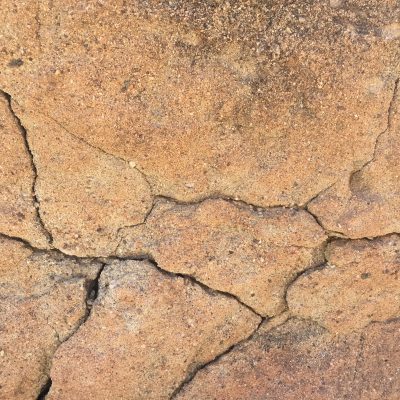 Warm tints on rock with many cracks