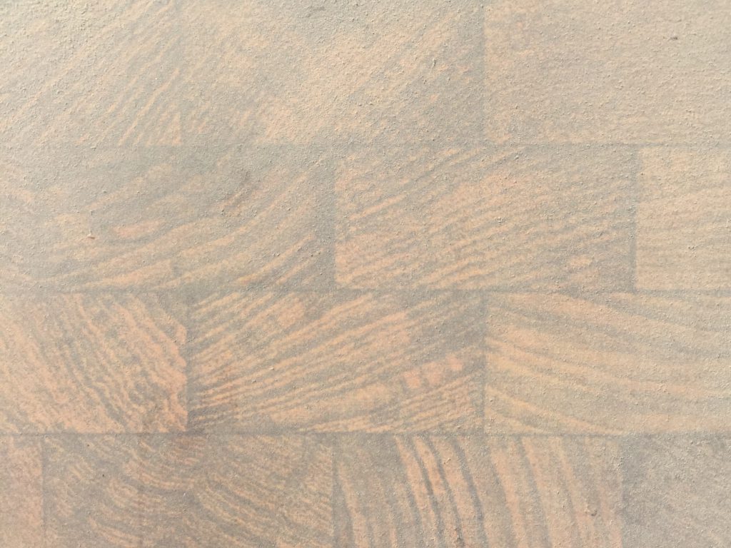 Wood table top covered in layer of thick dust